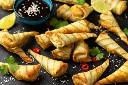 Photo for Fried Laksa cones with vegetables, lemongrass, coconut on rustic stone board. - Royalty Free Image