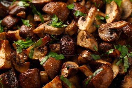 Photo for Delicious fried mushrooms with herbs and parsley in plate - Royalty Free Image
