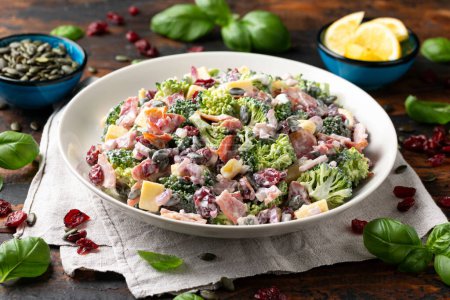 Photo for Healthy Homemade Broccoli Salad with bacon, red onion, cranberries, pumpkin seeds and cheese. - Royalty Free Image