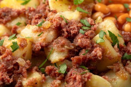 Corned beef hash with potatoes and beans in tomato sauce