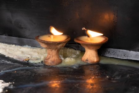 Photo for Prayer candle(Diyo) is lit by the devotees in temple, stupas as well as churches as a way of worshipping their god - Royalty Free Image