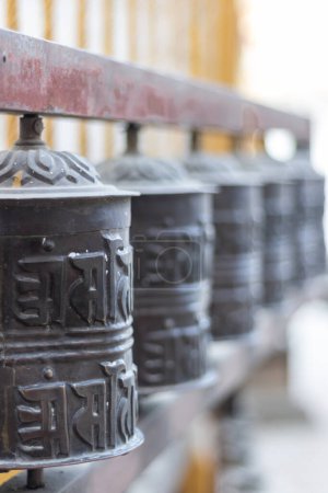 Photo for Prayer wheels is spun by devotees to aid for meditation and accumulating wisdom, good karma and putting negative energy aside - Royalty Free Image