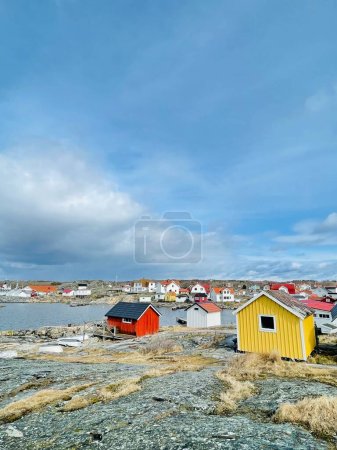 Photo for Vrango, Southern Gothenburg Archipelago, Sweden - 8 April 2022: A view of a village with wooden houses on Vrango, Southern Gothenburg Archipelago, Cloudy sky. - Royalty Free Image