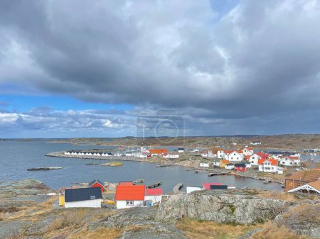 Photo for Vrango, Southern Gothenburg Archipelago, Sweden - 8 April 2022: A view of a village with wooden houses on Vrango, Southern Gothenburg Archipelago, Cloudy sky. - Royalty Free Image