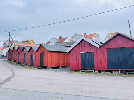 Photo for Donso, Southern Gothenburg Archipelago, Sweden - 8 April 2022: A view of a village with wooden houses on Donso, Southern Gothenburg Archipelago, Cloudy sky. - Royalty Free Image
