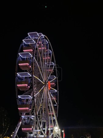 Photo for Tirana,Albania. 8 December 2022: Colorful ferris wheel in Tirana ,albanian capital city. Christmas and New Year atmosphere. Vertical photo, copy spase. - Royalty Free Image