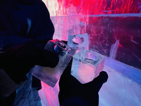 Photo for Close up of drink in glass made of ice in ice bar with other ice glasses in background. View from Famous Ice bar in Stockholm Sweden. - Royalty Free Image