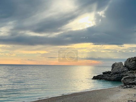 Photo for Scenic sunset over Ioninan sea in Vlore Albania. Beautiful rippling water with calm waves. Horizontal photo. Copy space. - Royalty Free Image