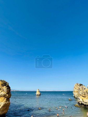 Photo for Lagos, Algarve Coast, Portugal - 12 August 2023: Busy beach on the Algarve coast on a summers day. People sunbathing and waiting to swim in the ocean. - Royalty Free Image