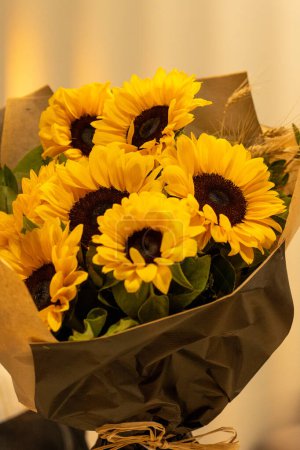 Photo for A beautiful bouquet of sunflowers stands in a vase . Bouquet for birthday , wedding ,in rustic style. copy space. Selective focus . Vertical photo. - Royalty Free Image