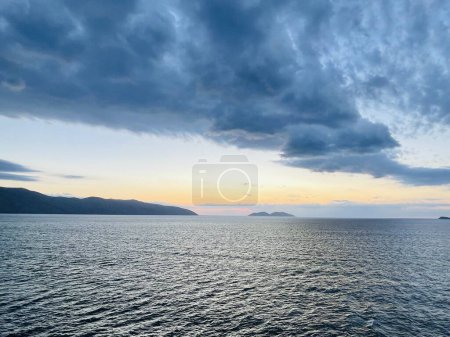Photo for Scenic sunset over Ioninan sea in Vlore Albania. Beautiful rippling water with calm waves. Horizontal photo. Copy space. - Royalty Free Image
