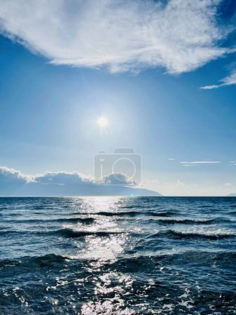 Photo for Scenic sunset over Ioninan sea in Vlore Albania. Beautiful rippling water with calm waves. Vertical photo. Copy space. Summer holidays concept background. - Royalty Free Image
