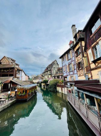 Photo for Colmar, France - 01 April 2024 : Urban medieval landscape of Alsace, water canal and traditional half timbered houses located in Colmar, France. Travel destination concept. Vertical Photo . - Royalty Free Image
