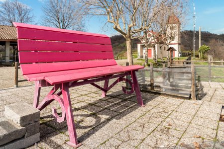 The Big red bench on the hill overlooking the Gattinara town, in the province of Vercelli, Piedmont, Italy