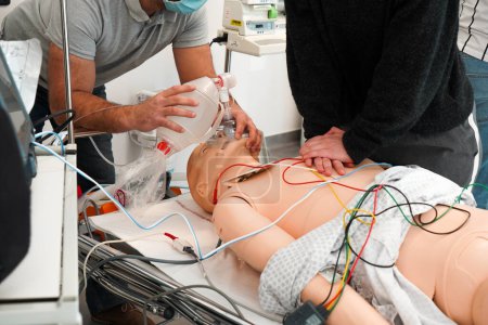 Photo for For two days, nurses and emergency nurses undergo training at the Montpellier School of Medicine on emergency procedures and resuscitation. Simulation session on a SimMan dummy. Cardiac massage and installation of a defibrillator. During cardiac mass - Royalty Free Image