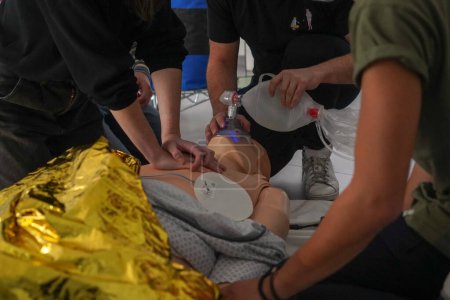 Photo for Emergency medicine students attends a circumstantial emergency simulation course led by two emergency physicians. In this case, the students will have to find the right gestures to revive a man victim of a drowning in hypothermia. - Royalty Free Image