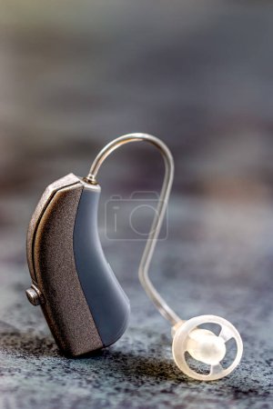 Photo for Earpiece in macro on gray background. - Royalty Free Image