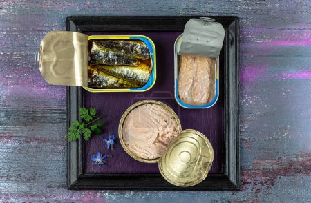 Photo for Open canned fish in a tray on purple tone. - Royalty Free Image