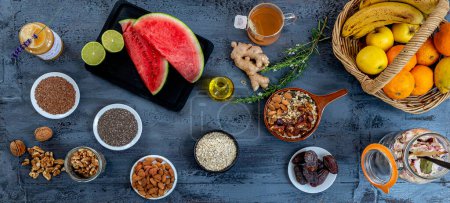 Photo for Set of organic food, dried fruits, seeds, citrus fruits, tea, honey and others, arranged on a gray worktop. - Royalty Free Image