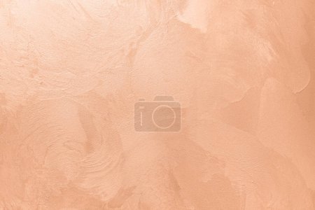 Abstract pink coral painted texture as background with copy space. Pattern in trendy color 2024 year Peach Fuzz. Vintage blank backdrop