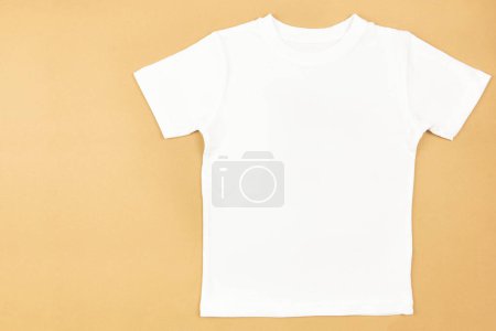White womens cotton tshirt mockup on craft paper background. Design t shirt template, print presentation mock up. Top view flat lay. 
