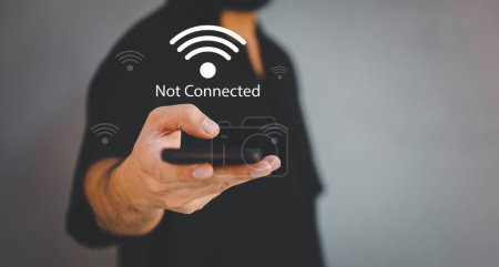 Photo for Man using a computer mobile to connect to wifi but wifi not connected, and waiting to loading digital business data form website. - Royalty Free Image
