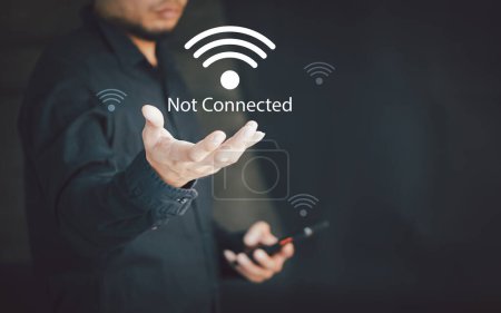 Photo for Man using a computer mobile to connect to wifi but wifi not connected, and waiting to loading digital business data form website. - Royalty Free Image