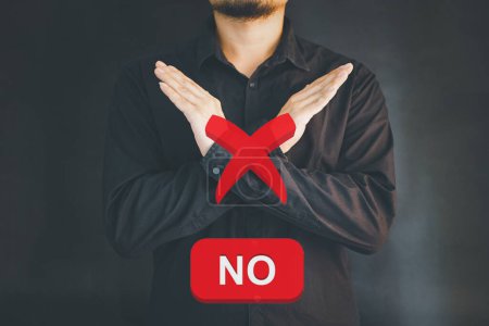 Photo for Serious-looking concerned asian male student showing forbid gesture, making cross sign to stop someone, disagree and prohibit action, telling no, enough. - Royalty Free Image