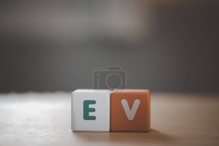 Photo for Wooden cubes with EV, on blurred nature background means electric car for campaign of save world, alternative, modern lifestyle concept. - Royalty Free Image