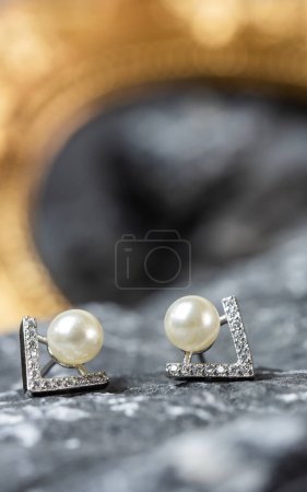 Foto de A beautiful Pearl Ear studs. Close-up of white pearl earrings. - Imagen libre de derechos