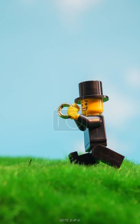 Photo for Bangkok, Thailand - October 3, 2022: Studio shot of Lego Groom running with ring to wedding ceremony. - Royalty Free Image