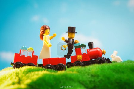 Photo for Bangkok, Thailand - October 3, 2022: Studio shot of Lego Groom Proposes to Bride on red train outdoor. - Royalty Free Image