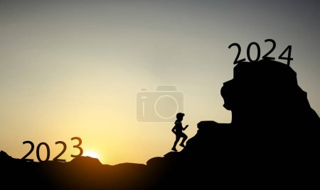Photo for Silhouette of person climbing mountains from 2023 to 2024 at sunset. - Royalty Free Image