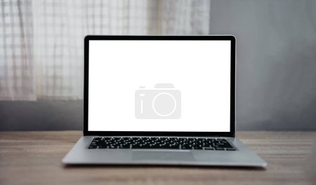 Photo for Table with open laptop featuring sleek silver design and black keyboard, highlighting technology, business, and communication aspects - Royalty Free Image