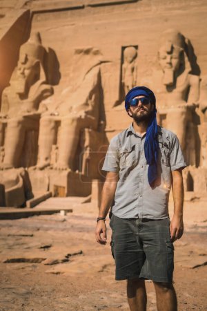 Portrait of a young tourist with a blue turban visiting the Abu Simbel Temple in southern Egypt in Nubia next to Lake Nasser. Temple of Pharaoh Ramses II, travel lifestyle