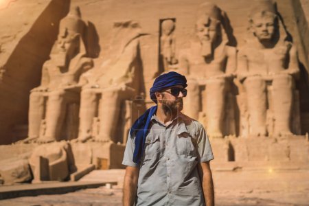 A young tourist with a blue turban visiting the Abu Simbel Temple in southern Egypt in Nubia next to Lake Nasser. Temple of Pharaoh Ramses II, travel lifestyle