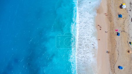 Aerial drone aerial shot in summer on paradise sandy beach Megali Petra in Lefkada. Beautiful crystal clear turquoise and blue waters. Greece