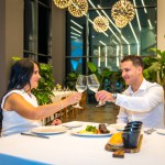 Couple toasting with white wine during a dinner in a luxury restaurant