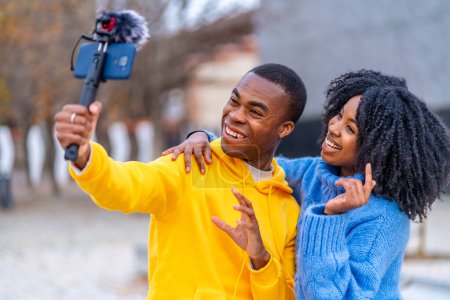 Photo for Two young african bloggers recording a video in the street - Royalty Free Image