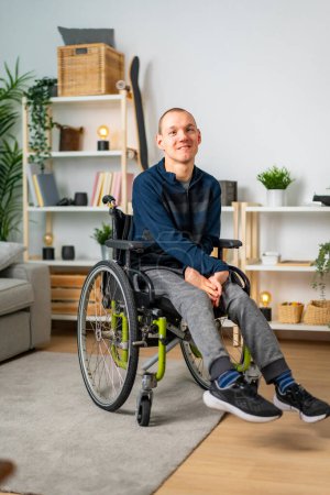 Photo for Vertical portrait of a happy disabled man in wheelchair at home - Royalty Free Image