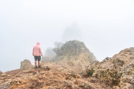 A tourist inside the fog on the very cloudy Pico de las Nieves in Gran Canaria, Canary Islands. Spain
