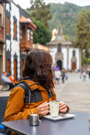 Eine Touristin ruht sich in der Gemeinde Teror aus und trinkt einen Kaffee. Gran Canaria, Spanien