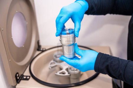 Expertise placing samples in a centrifuge machine for blood samples in a laboratory