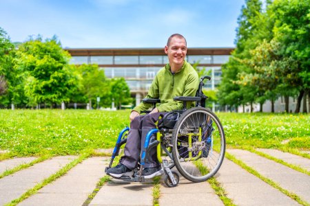 Full length portrait of a disabled man with cerebral palsy in the university campus