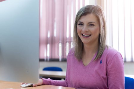 Photo for Young woman in programming school.Female student Learning In A Programing Class - Royalty Free Image