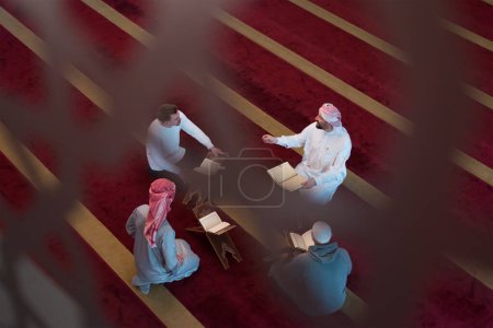 Photo for Read the Qur'an on the day of Ramadan. Group of Young Muslim people reading Qur'an at mosque - Royalty Free Image