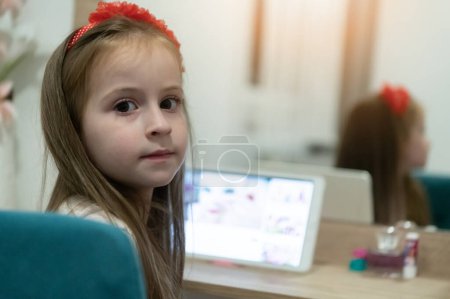 Photo for Little girl using her laptop in her room - Royalty Free Image