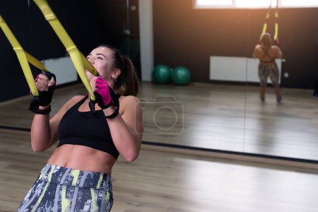 Photo for Young beautuful woman gym client  wearing sportswear motivated to exercise focused on her goal. Body training inside modern gym - Royalty Free Image