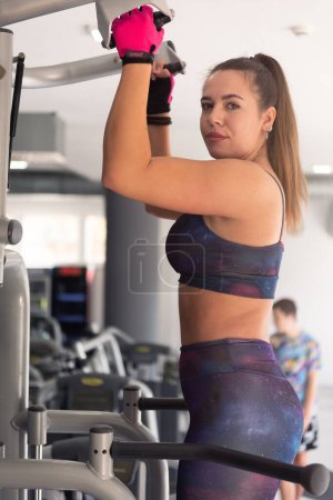 Photo for Young beautuful woman gym client  wearing sportswear motivated to exercise focused on her goal. Body training inside modern gym - Royalty Free Image