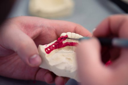 Photo for Dental technician working with tooth denture at prosthesis laboratory - Royalty Free Image